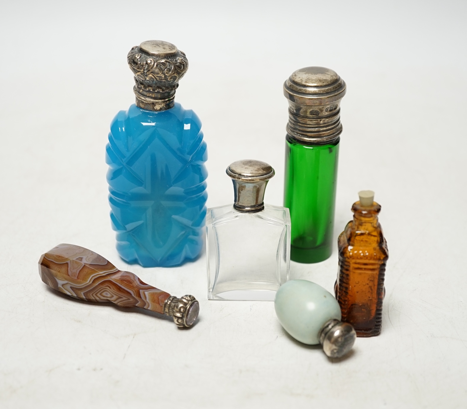 Five assorted mounted scent bottles including glass and ceramic egg shape, largest 94mm, together with a Victorian banded agate handled white metal desk seal. Condition - poor to fair